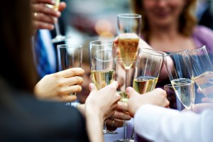 Glasses of champagne in hands of guests at wedding