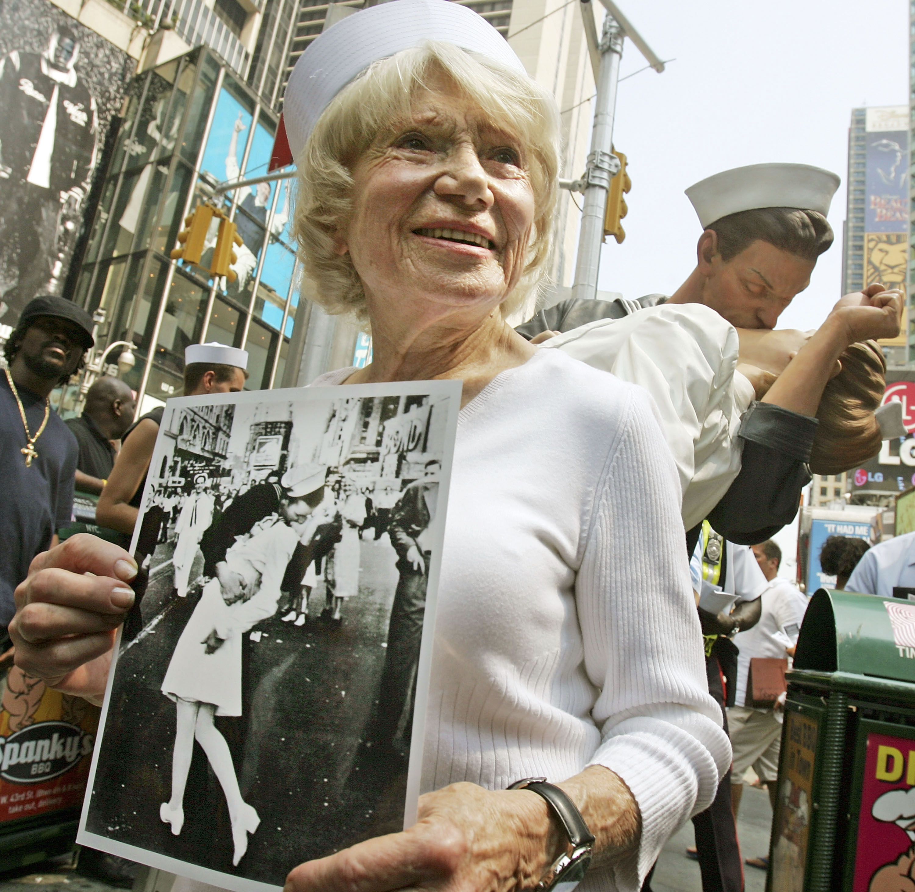 NEW YORK - AUGUST 11:  Eighty six-year-old Edith Shain stands in Times Square in front of a statue of her famous kiss with a sailor on V-J Day at the end of World War II August 11, 2005 in New York City. The famous kiss was photographed by Alfred Eisenstaedt and the unveiling of the statue coincides with the 60th anniversary of the end of World War II on August 14, 1945. The sailor in the photograph has never been positively identified.  (Photo by Mario Tama/Getty Images)