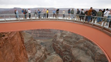 People walk on the Skywalk during the First Walk event at the Grand Canyon on the Hualapai Indian Reservation at Grand Canyon West, Ariz., Tuesday, March 20, 2007. The Skywalk opens to the general public on March 28. (AP Photo/Ross D. Franklin)