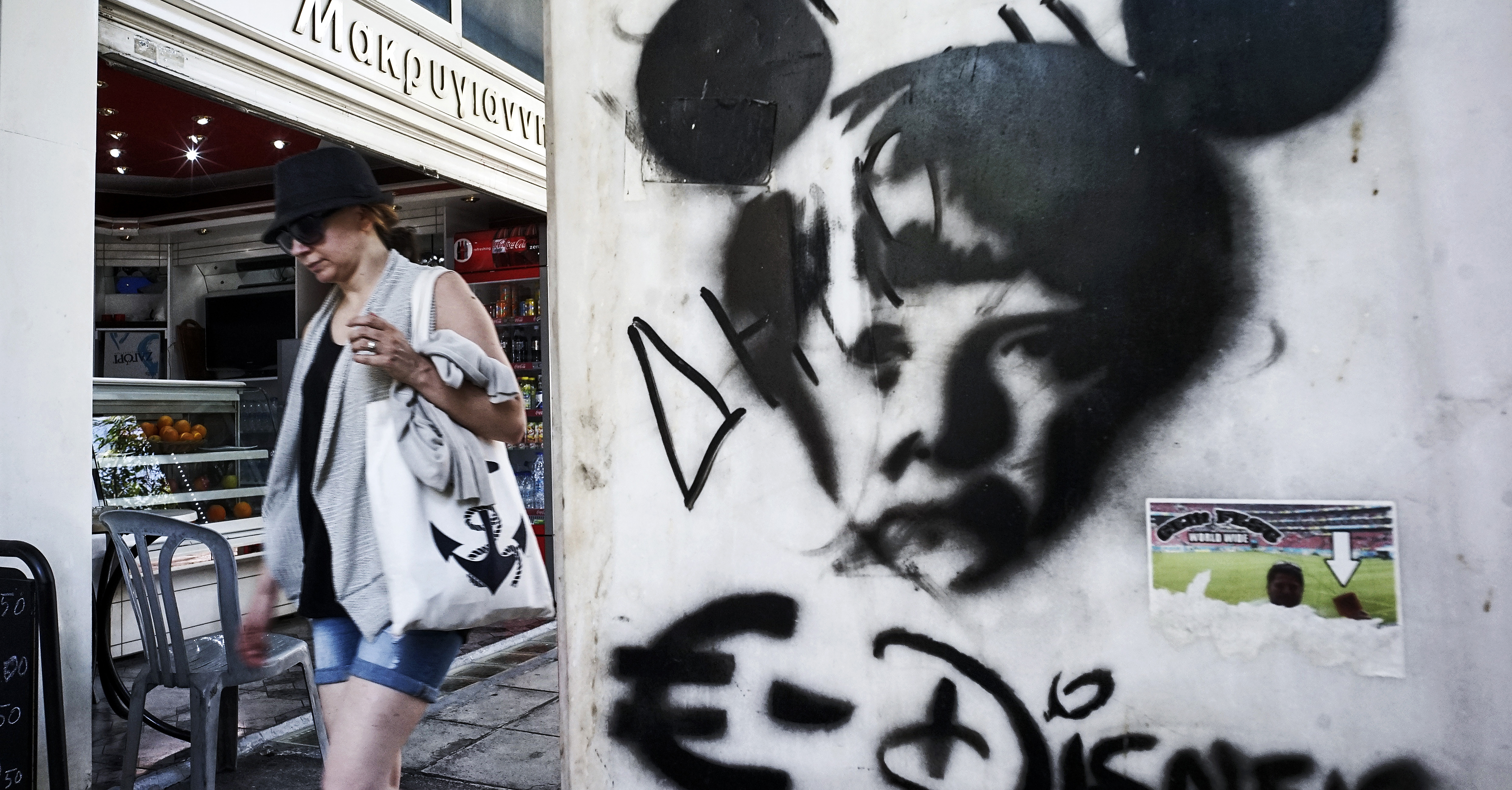 ATHENS, GREECE - JUNE 15: Graffiti showing German Cancellor Angela Merkel as a mouse to compare the European Union with Disney on June 15, 2015 in Athens, Greece. The European Commission has said that Greece and its international creditors need to come to an agreement within the next 2 weeks to avoid a possible default, after weekend talks collapsed. (Photo by Milos Bicanski/Getty Images)