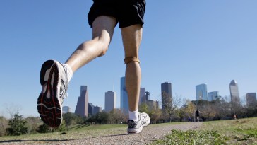 FILE - In this Jan. 12, 2009 file photo, a jogger runs near downtown Houston. ESoles Inc., a startup in Scottsdale, Ariz. which makes custom insoles for athletic shoes, has created prototype insoles with pressure sensors that relay their information wirelessly to a nearby cell phone. (AP Photo/David J. Phillip, File)