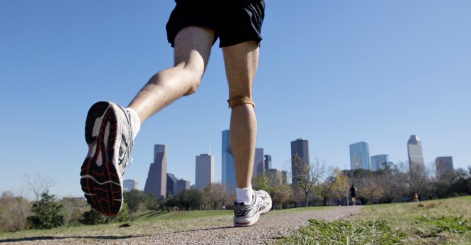 FILE - In this Jan. 12, 2009 file photo, a jogger runs near downtown Houston. ESoles Inc., a startup in Scottsdale, Ariz. which makes custom insoles for athletic shoes, has created prototype insoles with pressure sensors that relay their information wirelessly to a nearby cell phone. (AP Photo/David J. Phillip, File)