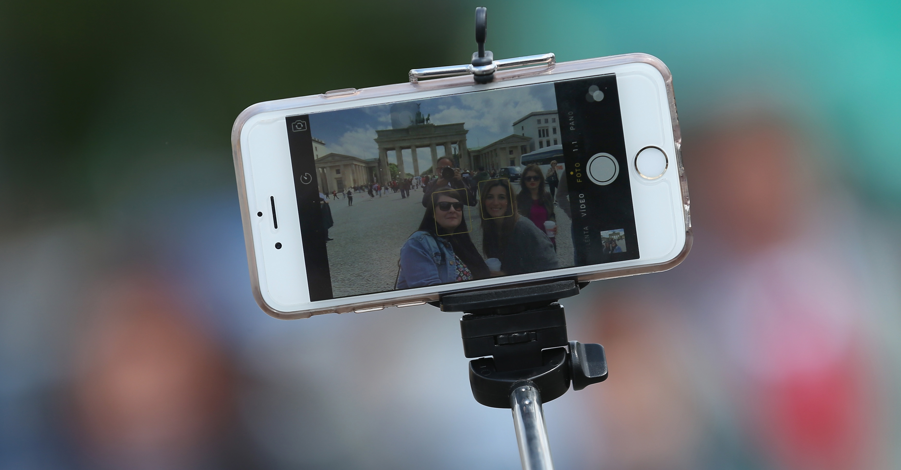 BERLIN, GERMANY - MAY 19:  Tourists photograph themselves with a smartphone attached to a selfie stick at the Brandenburg Gate on May 19, 2015 in Berlin, Germany. Selfie sticks are becoming a common site across the globe and some museums and other tourist attractions have banned them.   (Photo by Sean Gallup/Getty Images)