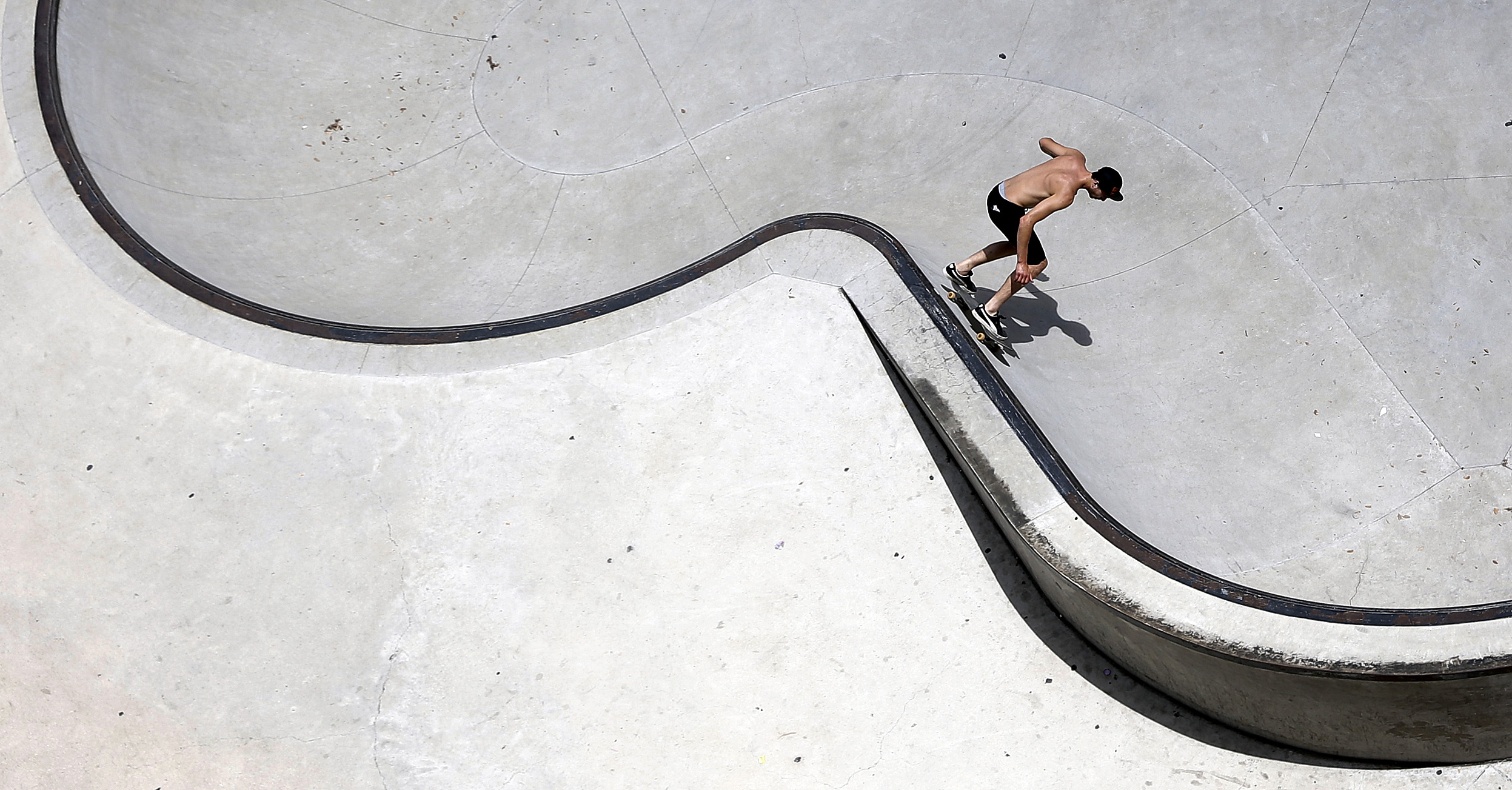 A skateboarder balances his board along a wall in a skateboard park, Thursday, June 25, 2015, in Austin, Texas. (AP Photo/Eric Gay)