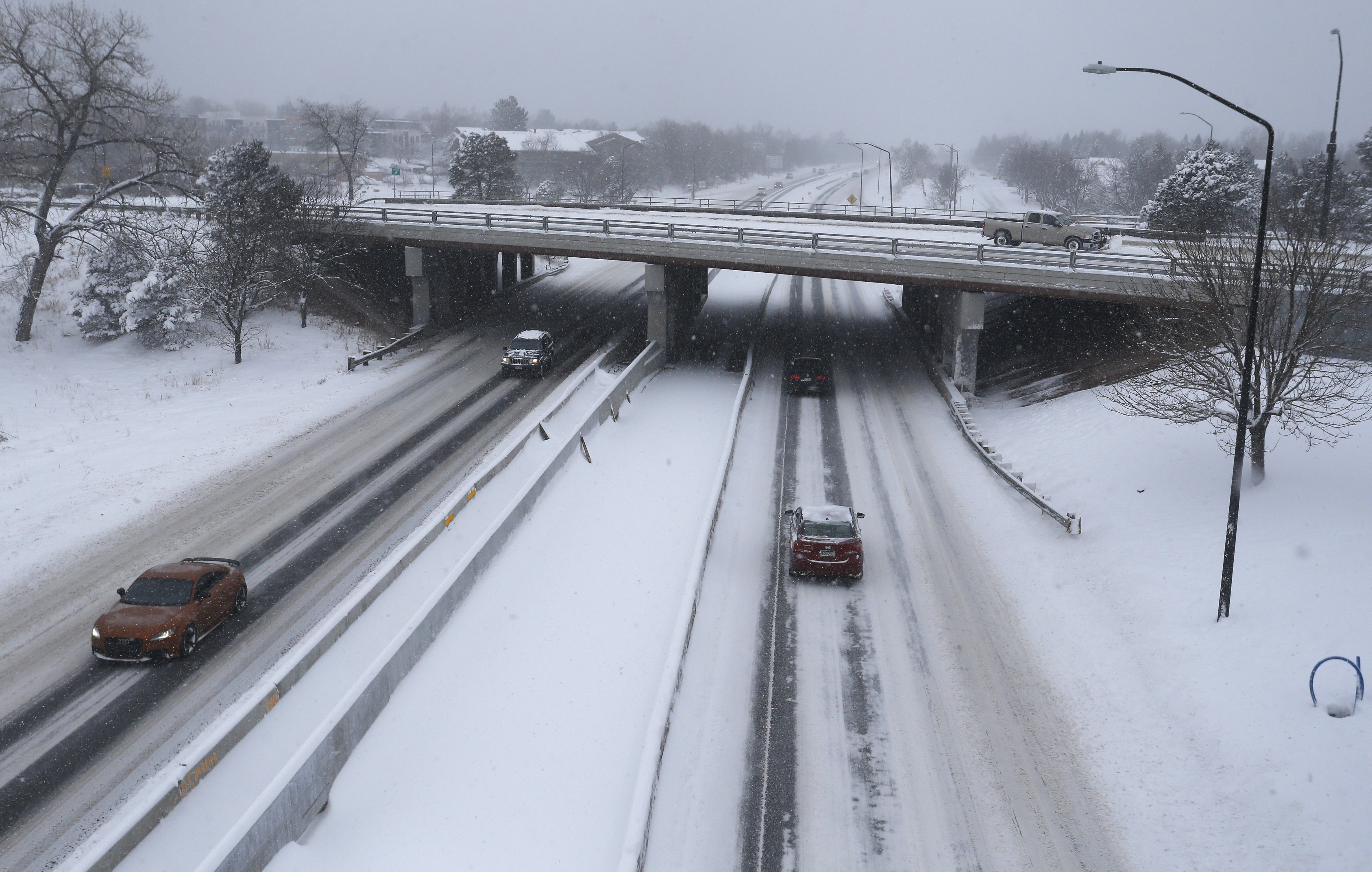 Motorists brave slippery roads after a night of heavy snowfall, in Boulder, Colo., Tuesday, Dec. 15, 2015. The biggest winter storm to hit the Denver area so far this season has left most schools closed and created some havoc on the roads for those forced to commute. (AP Photo/Brennan Linsley)