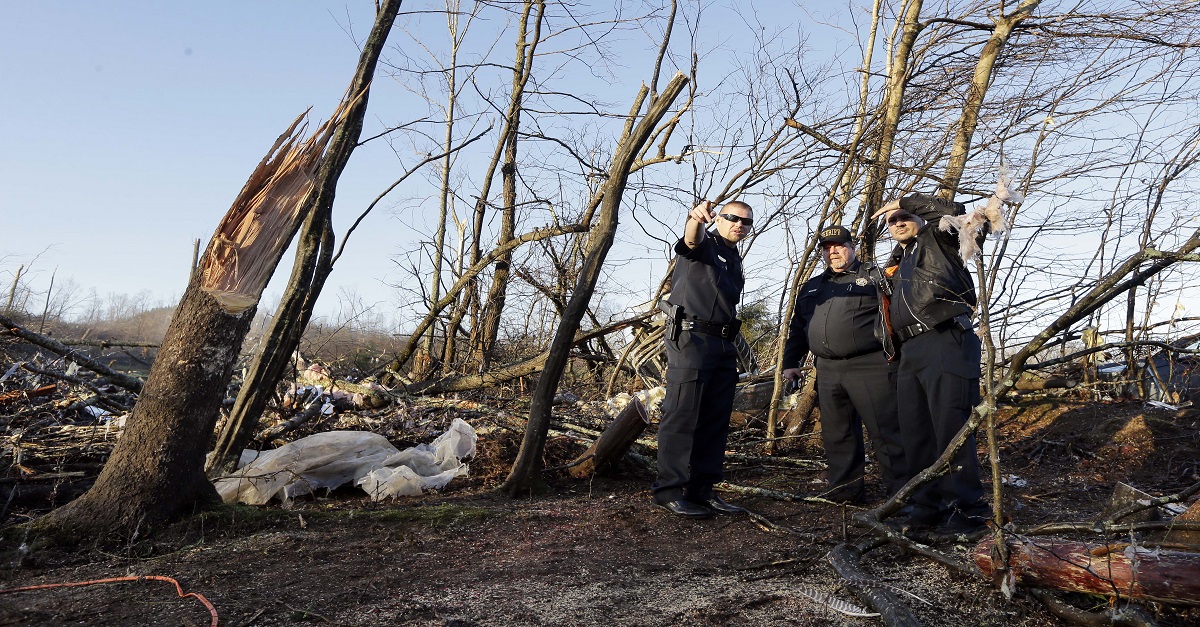 Members of the Perry County Sheriff's Department look over the site where Antonio Yzaguirre, 70, and his wife, Ann Yzaguirre, 69, were found dead, near Linden, Tenn., Thursday, Dec. 24, 2015. Several people were killed in Mississippi, Tennessee and Arkansas as spring-like storms mixed with unseasonably warm weather spawned rare Christmastime tornadoes in the South. (AP Photo/Mark Humphrey)