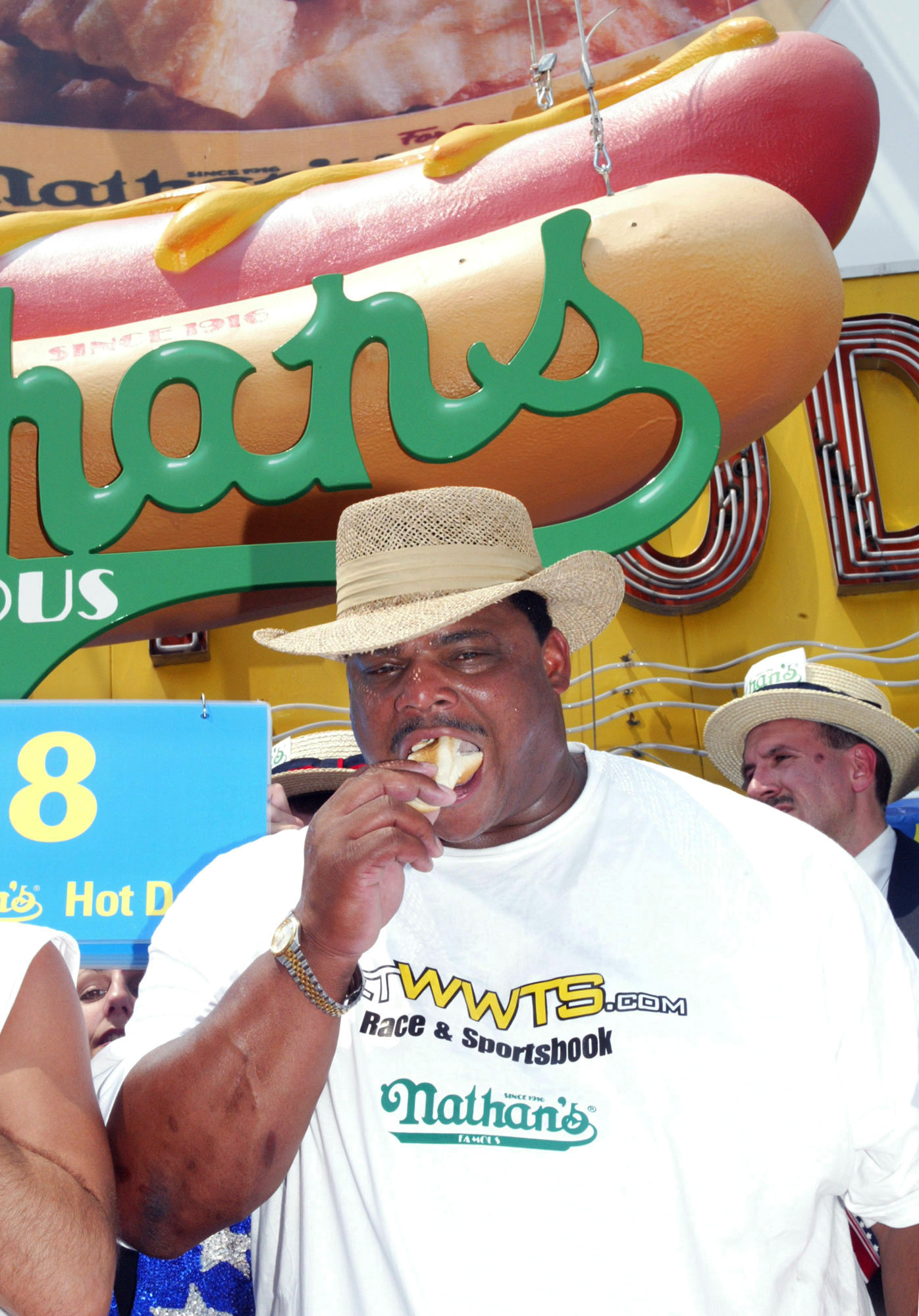 Former Chicago Bears football star William "the Refrigerator" Perry competes in the Nathan's Famous Fourth of July Hot Dog Eating Contest Friday, July 4, 2003, in New York's Coney Island. Perry conceded after eating only four hot dogs and buns in five minutes while the defending champion Takeru Kobayashi of Japan came in first place by eating 44 1/2 hot dogs and buns in twelve minutes. (AP Photo/Akira Ono)