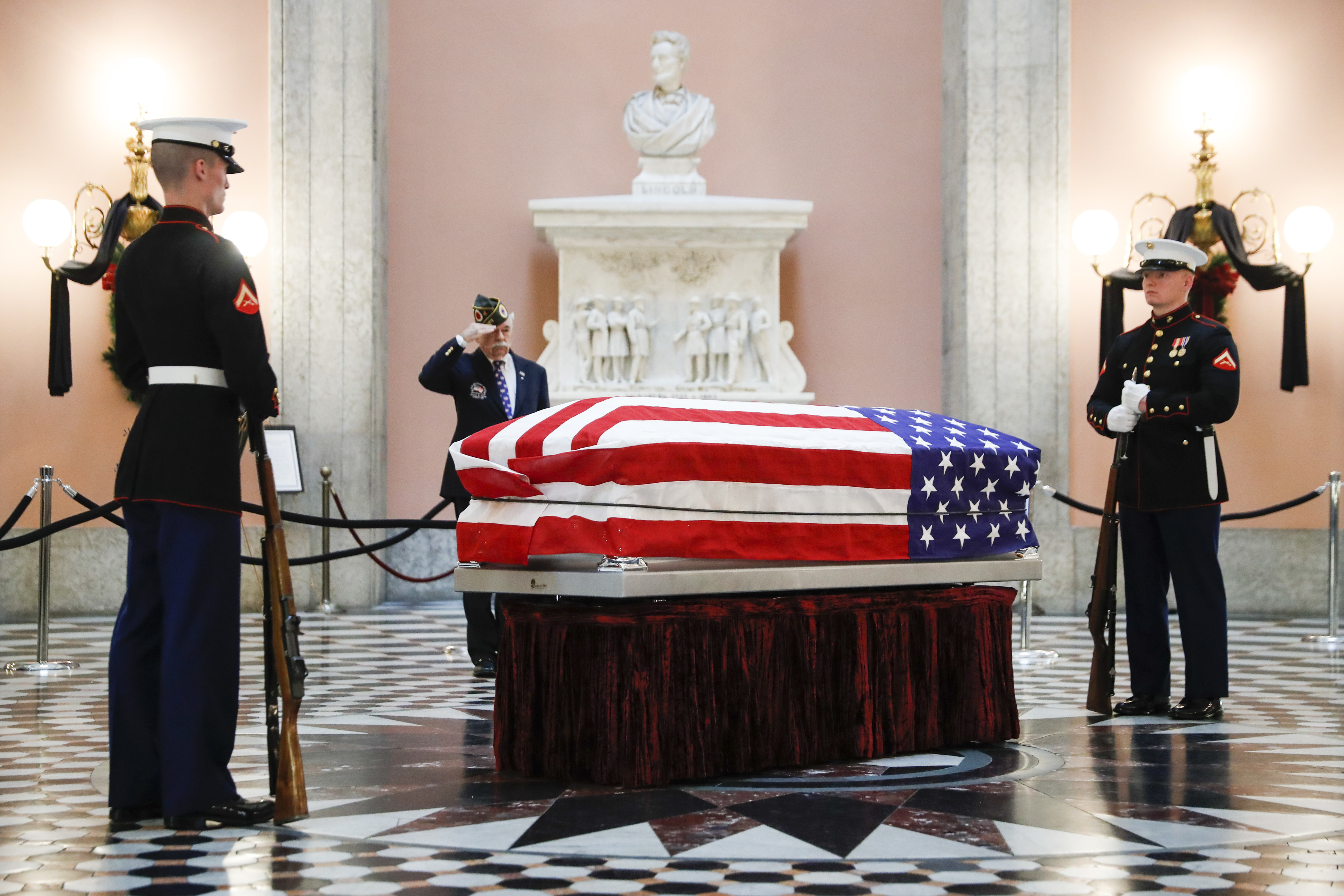 Marines stand guard at the casket of the John Glenn as he lies in repose, Friday, Dec. 16, 2016, in Columbus, Ohio. Glenn's home state and the nation began saying goodbye to the famed astronaut as he lies in state at Ohio's capitol building. Glenn, 95, the first American to orbit Earth, died last week. (AP Photo/John Minchillo)