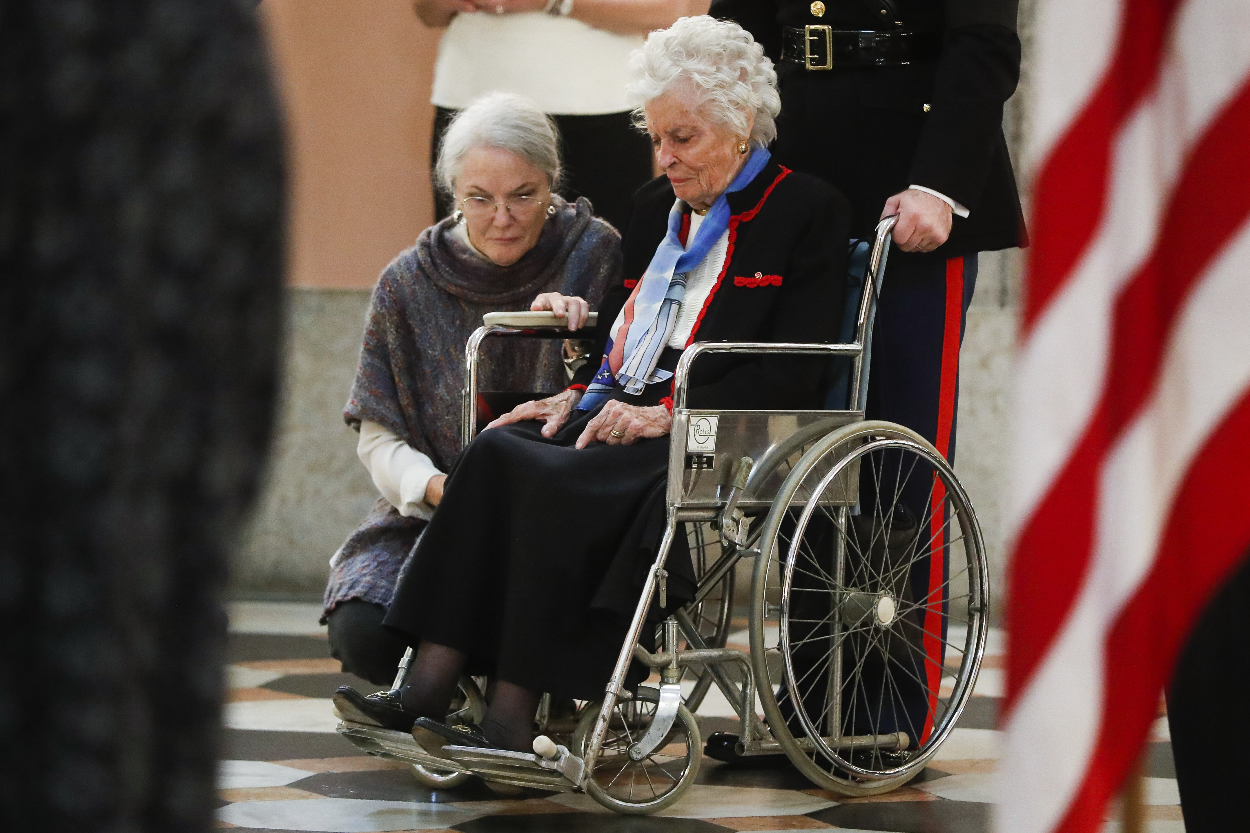 Annie Glenn, center right, pauses after viewing her husband John Glenn's casket alongside her daughter Carolyn Ann Glenn, center left, as he lies in honor, Friday, Dec. 16, 2016, in Columbus, Ohio. Glenn's home state and the nation began saying goodbye to the famed astronaut who died last week at the age of 95. (AP Photo/John Minchillo)