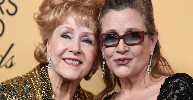 Debbie Reynolds, winner of the Screen Actors Guild lifetime award, left, and Carrie Fisher pose in the press room at the 21st annual Screen Actors Guild Awards at the Shrine Auditorium on Sunday, Jan. 25, 2015, in Los Angeles. (Photo by Jordan Strauss/Invision/AP)