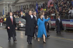 President Bush and first lady Laura Bush wave as they walk down Pennsylvania Avenue during the Inaugural Parade Saturday, Jan. 20, 2001, in Washington. (AP Photo/Doug Mills)