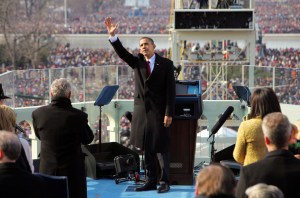 President Barack Obama waves to the crowd just after he was sworn-in as the 44th President of the United States and the first African-American to lead the nation at the Capitol in Washington Tuesday, Jan. 20, 2009. Former President George W. Bush stands and applauds at left. (AP Photo/J. Scott Applewhite)