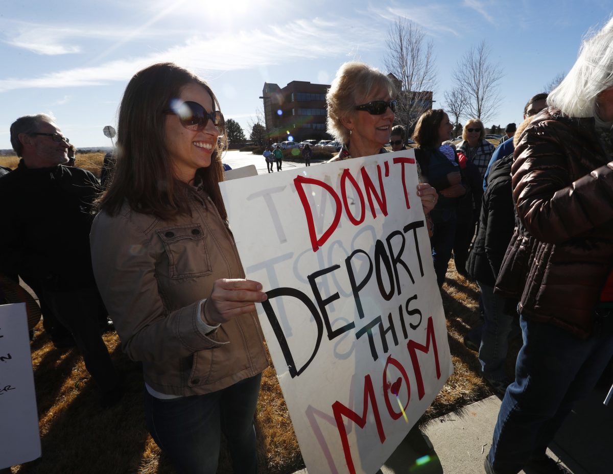 Supporters hold up a placard during a rally in for Jeanette Vizguerra, a Mexican woman seeking to avoid deportation from the United States, outside the Immigration and Customs Enforcement office Wednesday, Feb. 15, 2017, in Centennial, Colo. U.S. immigration authorities have denied Vizguerra request to remain in the country. (AP Photo/David Zalubowski)
