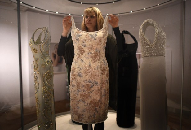LONDON, ENGLAND - FEBRUARY 16: (EXCLUSIVE COVERAGE) A member of staff poses with a dress designed by Catherine Walker, which Princess Diana wore to a Christies Auction Gala in New York in 1997, during a preview for the forthcoming 'Diana: Her Fashion Story' exhibition at Kensington Palace on February 16, 2017 in London, United Kingdom. On August 31st this year it will be 20 years since Princess Diana died in a car accident in Paris. As part of the events commemorating her life Kensington Palace are showing a number of her dresses in a new exhibition 'Diana: Her Fashion Story' which opens to the public on February 24th. (Photo by Carl Court/Getty Images)