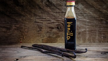 vanilla extract, homemade in a small bottle and vanilla beans on