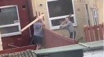 Watch: Neighbors Get Into Hilarious Over-The-Fence Plank War!