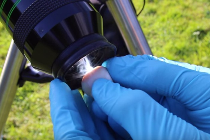 A scientist holds an eyeball under a telescope, and when it lights on fire, it’s terrifying