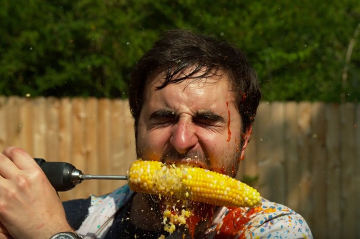 Guys eating corn off a drill in slow motion is totally gross