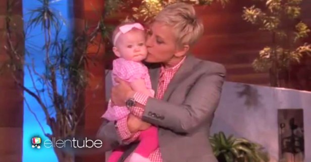 Ellen DeGeneres is holding this baby tight as she gives the girl a moment in the spotlight