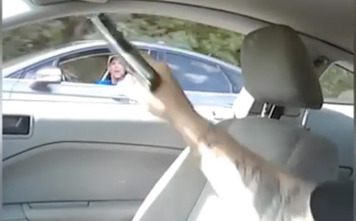 Driver brandishes a handgun at a loudmouthed motorist to teach people a lesson about road rage