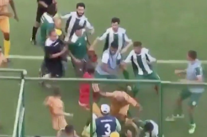 On-field collision leads to one of the craziest soccer brawls of all time, as fans climb walls to escape
