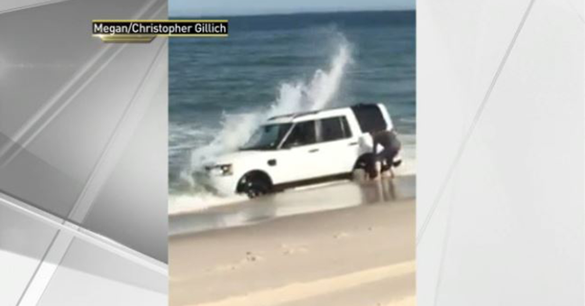 This guy was so busy taking pictures, he didn’t see his SUV getting washed into the ocean