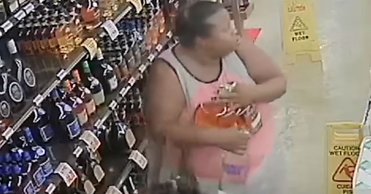 Security cameras catch thief stuffing liquor bottles in her pants