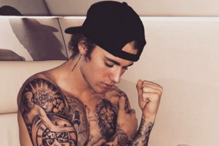Justin Bieber shows of his spiritual side while enjoying a topless airplane journey