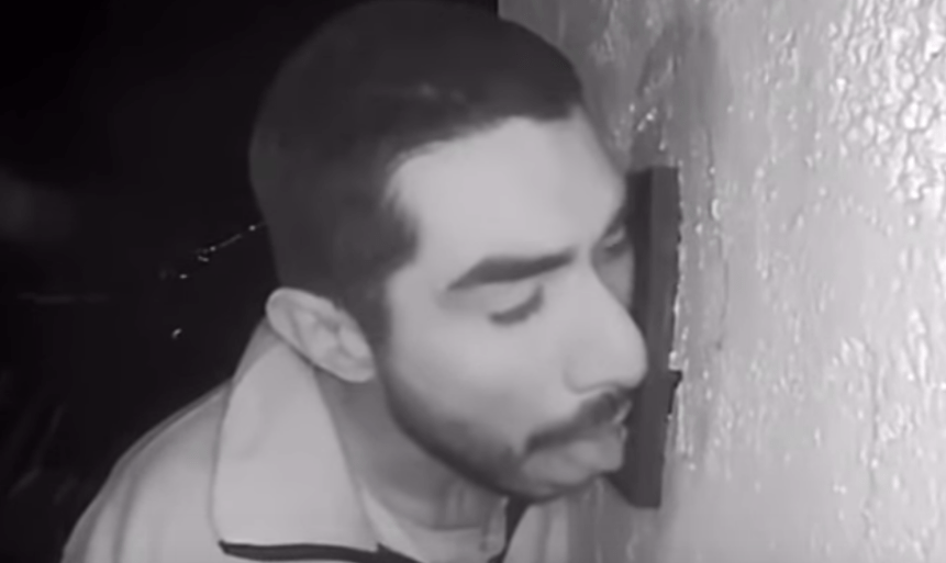 man licking doorbell