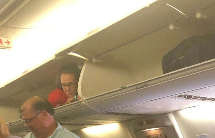 Southwest Airlines Flight Attendant Crawls Into Overhead Compartment To Greet Passengers